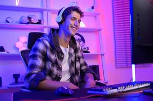 Young Caucasian man Pro Gamer have live streaming  and chatting  with his  fans at home photo