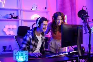 Young professionals  play video games together live streaming their matches  and speak with their fans at  homes. photo