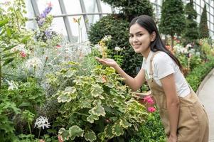 Young gardener woman feeling happy working in her farm photo