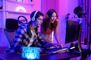 Young professionals  play video games together live streaming their matches  and speak with their fans at  homes. photo