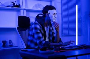 A Hacker is using laptop computer to steal data in the night photo