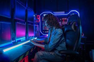 an asian woman programmer is working in her computer room , futuristic technology concept photo