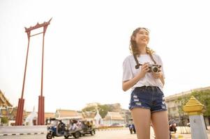 Beautiful young Asian tourist woman on vacation sightseeing and exploring Bangkok city, Thailand, Holidays and traveling concept photo