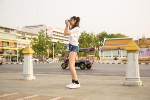 Beautiful young Asian tourist woman on vacation sightseeing and exploring Bangkok city, Thailand, Holidays and traveling concept photo