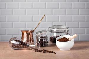 Coffee beans and ground coffee in glass and porcelain containers. Traditional Turkish cezve. photo