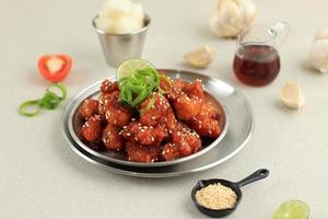 Korean Fried Chicken Yangnyeom Tongdak with Spicy Sauce and Sesame Seed photo