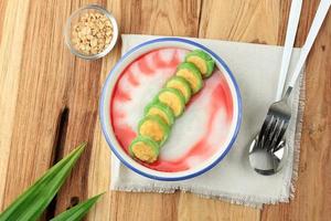 Es Pisang Ijo, Ripe Banana Rolled with Green Thin Crepes. photo