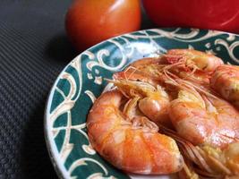 Shrimps in plate on a grey concrete background photo