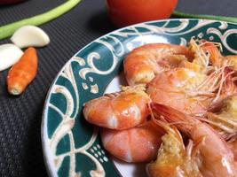 Shrimps in plate on a grey concrete background photo