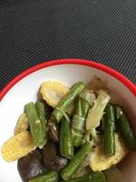 cooking corn and long bean vegetables in a bowl photo