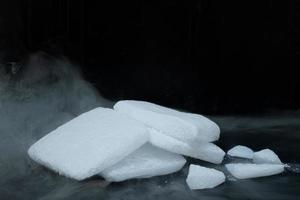 Dry ice cubes stacked on black background photo