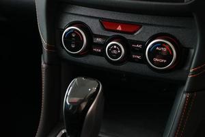 The switch button panel controls the operation of the car air conditioning system. photo