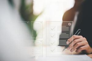 Businessman checking the steps through document with a list of checkboxes ,regulation ,Concepts of practices and policies ,procedure company articles of association Terms and Conditions photo