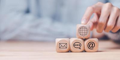 Man pointing at a wooden block,Communication concept with email, message box and contacts icons,Website page contact,Connection with modern network technology,borderless communication ,contact us photo