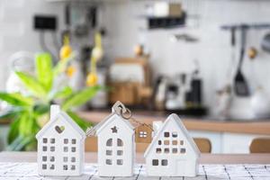 llave a casa de acogedor hogar en mesa de cocina. edificio, diseño, proyecto, Moviente a nuevo casa, hipoteca, seguro, alquilar y compra real inmuebles foto