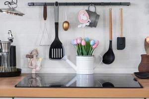 Interior of kitchen and details of decor of utensils with Easter decoration of colorful eggs in a loft style. Festive interior of a country house photo