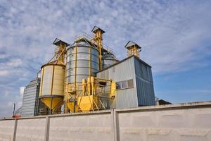 agro silos on agro-industrial complex and grain drying and seeds cleaning line. photo