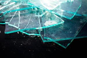 Broken glass pile pieces texture and black background photo