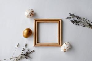 Easter eggs on a gold  and wooden frame background on a white background. photo