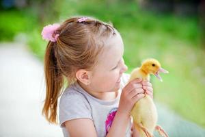 Little girl holds up and smokes on a  duck photo