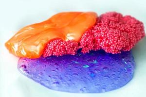 Mix of orange, pink and purple slime. Liquid art gel background. photo