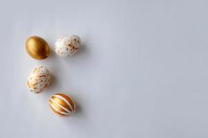 Top view Easter eggs painted with gold paint in various patterns . White background. photo