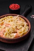 Delicious farfalle pasta with langoustine shrimp with creamy sauce photo