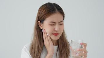 Asian woman feel sensitive teeth after drinking cold, female suffer tooth, decay problems, dental care, tooth extraction, decay problem, bad breath, Gingival Recession, Oral Hygiene instruction video