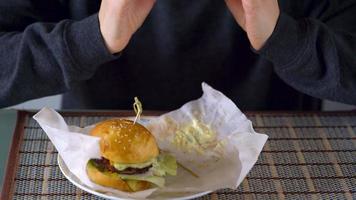 Woman eats juicy hamburger video