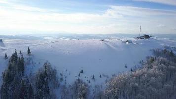 Flight over the research station on top of Carpathian mountains covered with snow. Clear frosty weather video