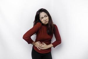 Photo of young unwell sick ill woman hold hand on stomach suffers pain isolated on white background