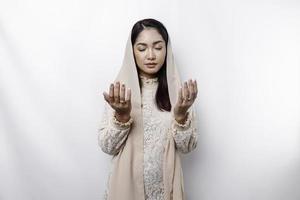 Religious beautiful Asian Muslim girl wearing a headscarf praying to God. photo