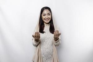 Religious beautiful Asian Muslim girl wearing a headscarf praying to God. photo