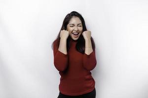 A young Asian woman with a happy successful expression wearing red top isolated by white background photo