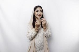 Religious beautiful Asian Muslim girl wearing a headscarf praying to God. photo