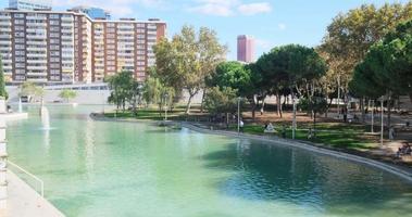 Parc de l Espanya Industrial. Public park with lawns and trees, lake and sculptures video