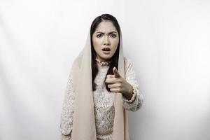 A portrait of an Asian Muslim woman wearing a headscarf isolated by white background looks depressed photo