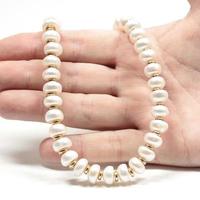 Pendant necklace bracelet of precious pearls on a white background photo