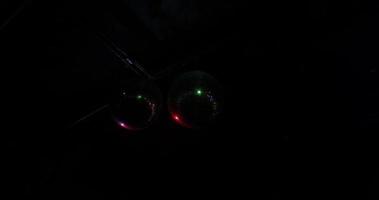Two Disco Ball glitter ball reflects multi colored rays. Night club interior. Dark party background with copy space video