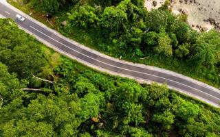 Aerial view of empty road with green forest photo