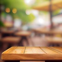 Wooden table top in cafe blurred bokeh background - image photo