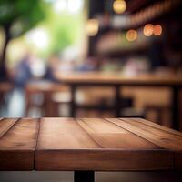 Wooden table top in cafe blurred bokeh background - image photo