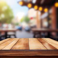 Wooden table top in cafe blurred bokeh background - image photo