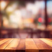 Wooden table top in cafe blurred bokeh background - image photo