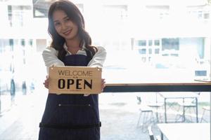 Portrait of a woman, a coffee shop business owner smiling beautifully and opening a coffee shop that is her own business, Small business concept. photo