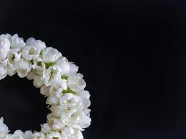 Close up part of Thai traditional style, jasmine garland, symbol of mother day, homage to a Buddha Jasmine, Maalai, art design, in dark background with blank copy space photo