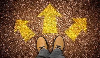 Yellow Leather Shoes and Three Geometrical Chalky Arrows on Ground - Choice Concept photo