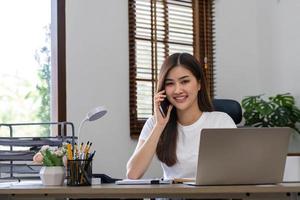 negocio mujer utilizando calculadora para hacer matemáticas Finanzas en de madera escritorio en oficina y negocio trabajando fondo, impuesto, contabilidad, Estadísticas y analítico investigación concepto. foto