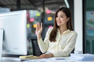 Business woman using calculator for do math finance on wooden desk in office and business working background, tax, accounting, statistics and analytic research concept. photo