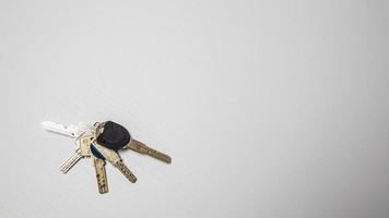 Keys on a white background. The concept of buying a new house. photo